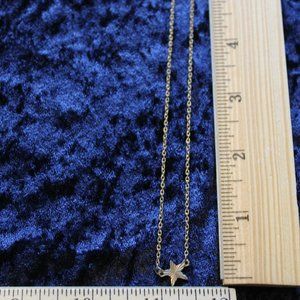 Silver toned necklace with star